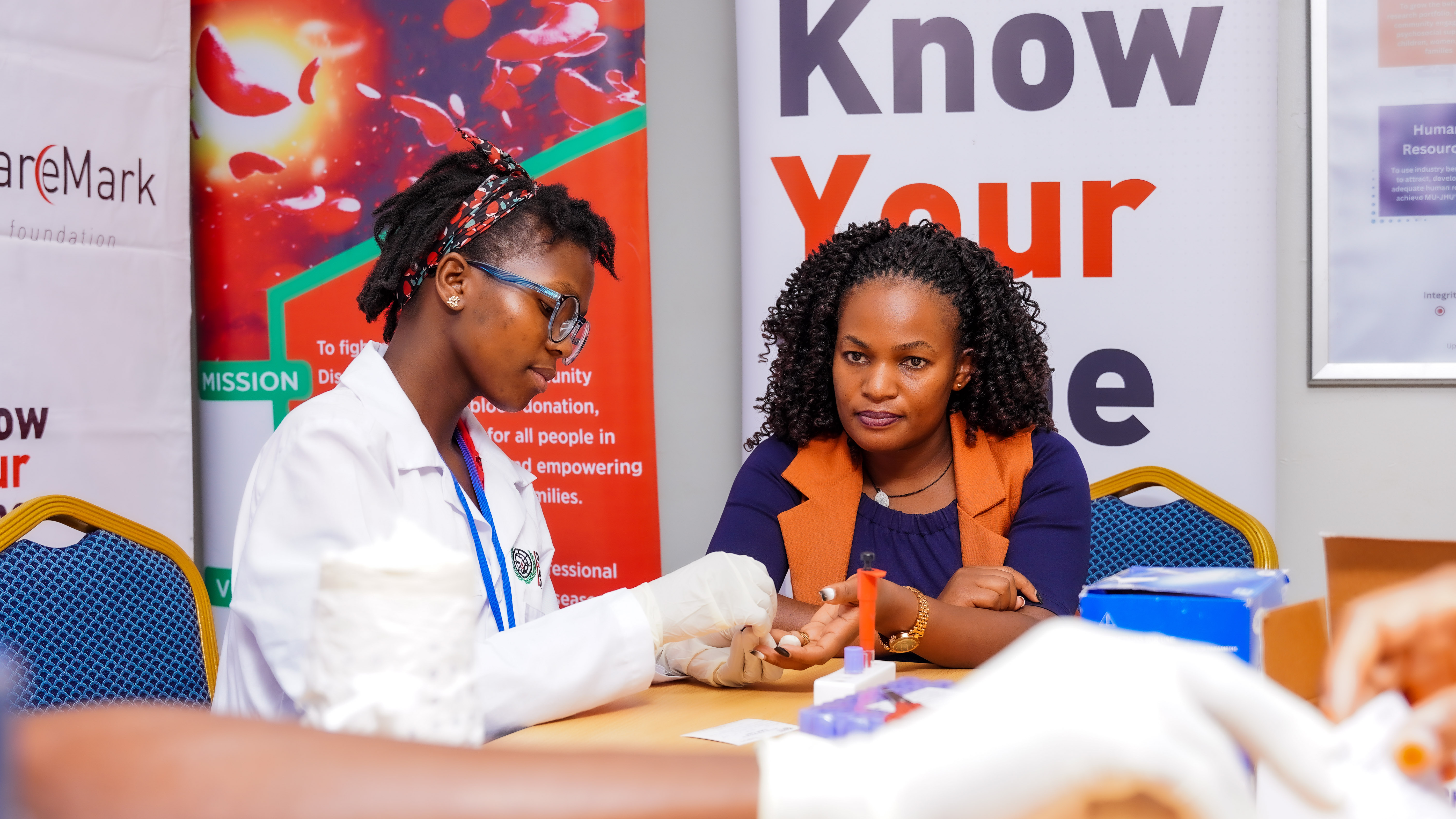 A sickle cell warrior receiving emotional and physical support from a TSCA volunteer.